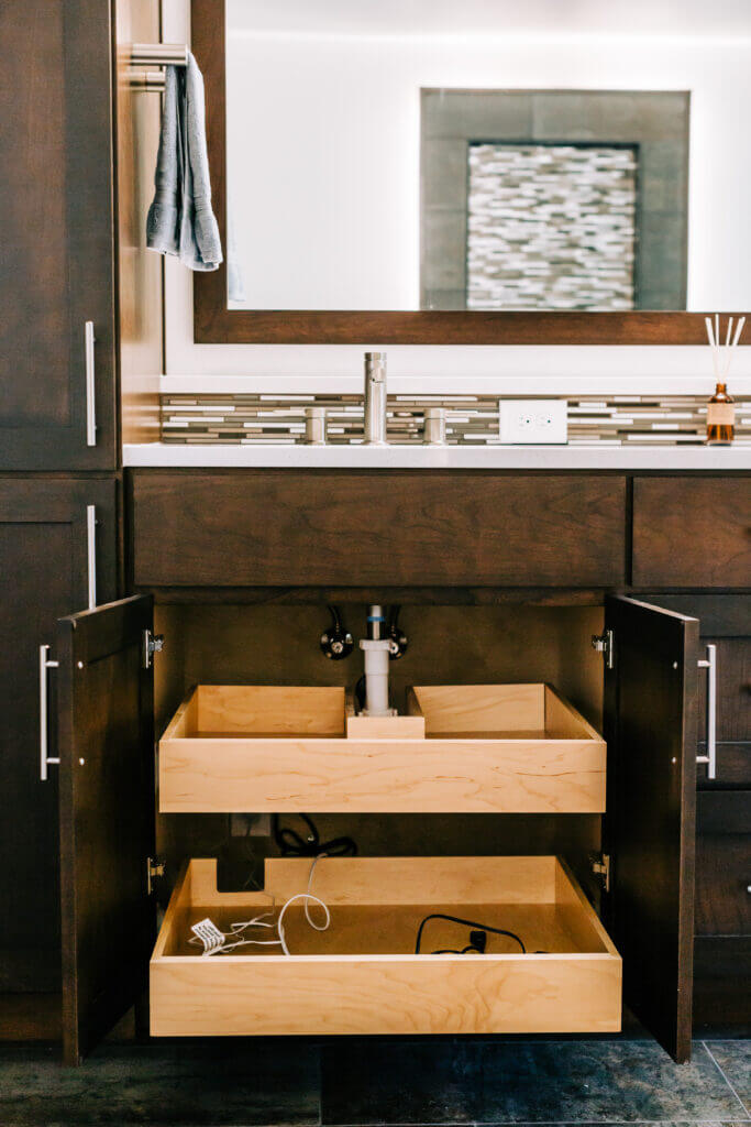 No wasted space! Custom sliding drawer under the bathroom sink. Very  clever!
